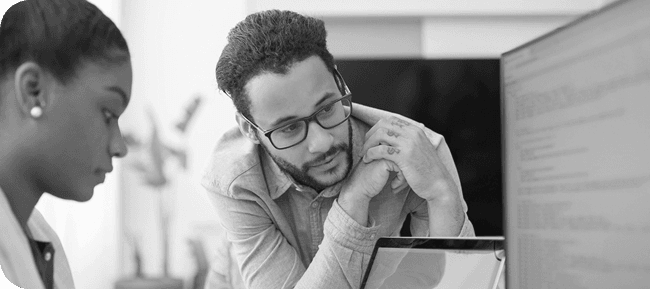 man and woman looking at a computer